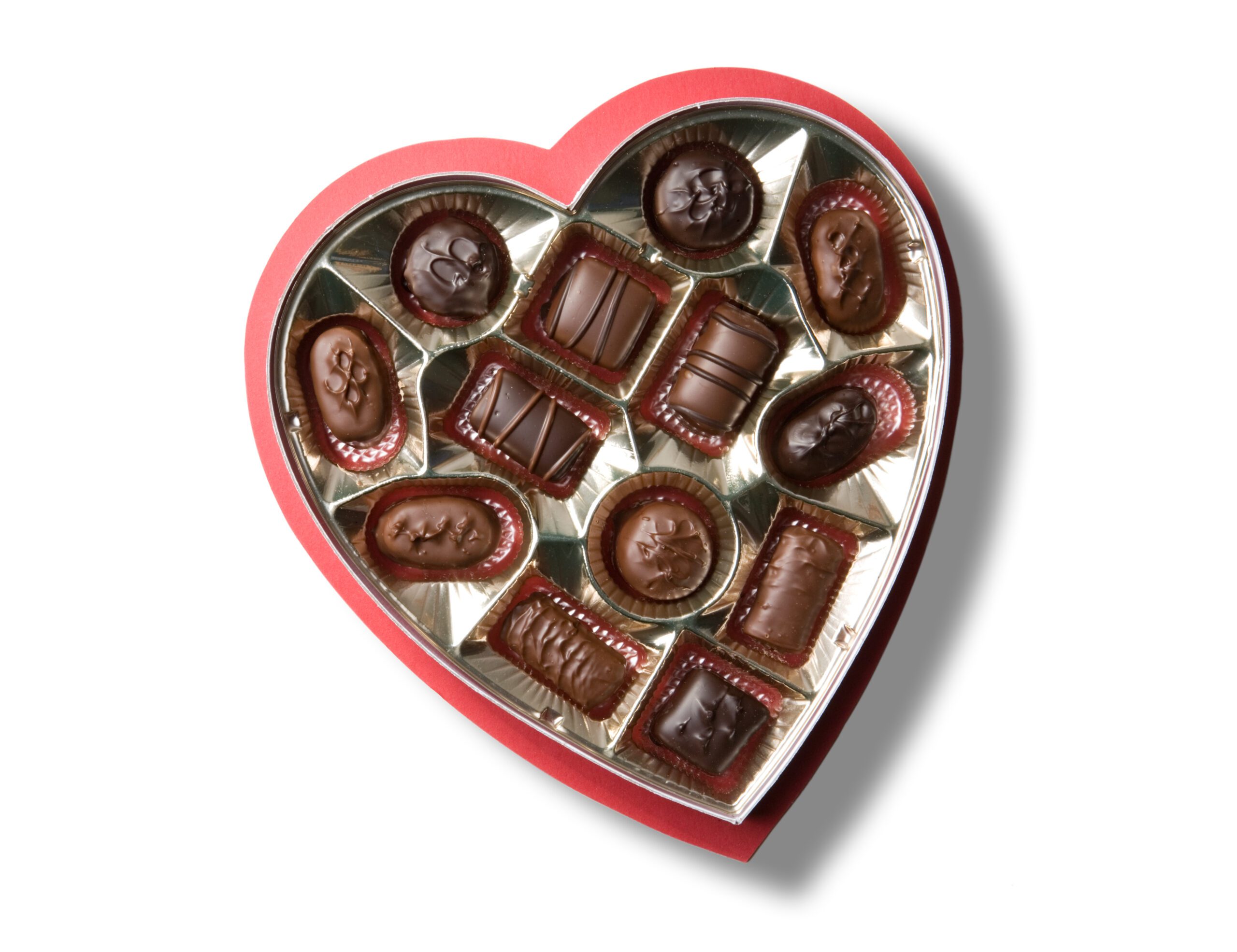 A heart shaped box of chocolates for Valentine's Day. Isolated on white with clipping path.